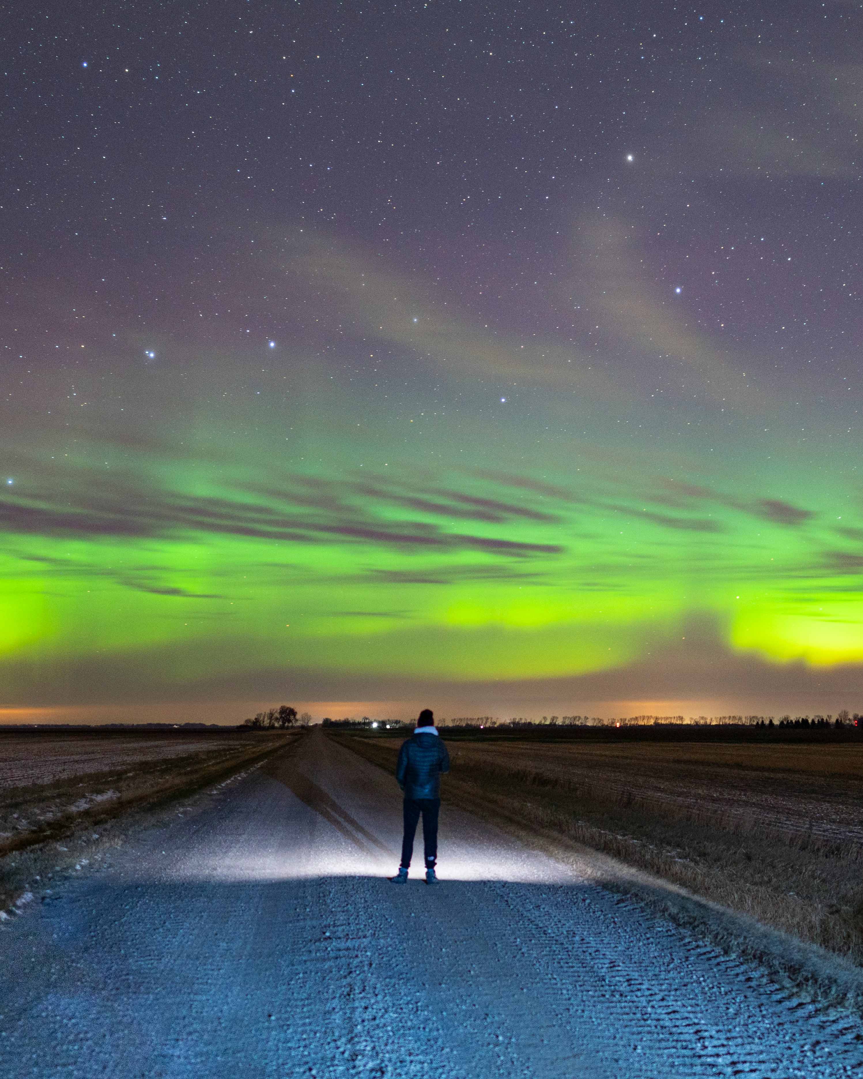 man and woman walking on road during night time